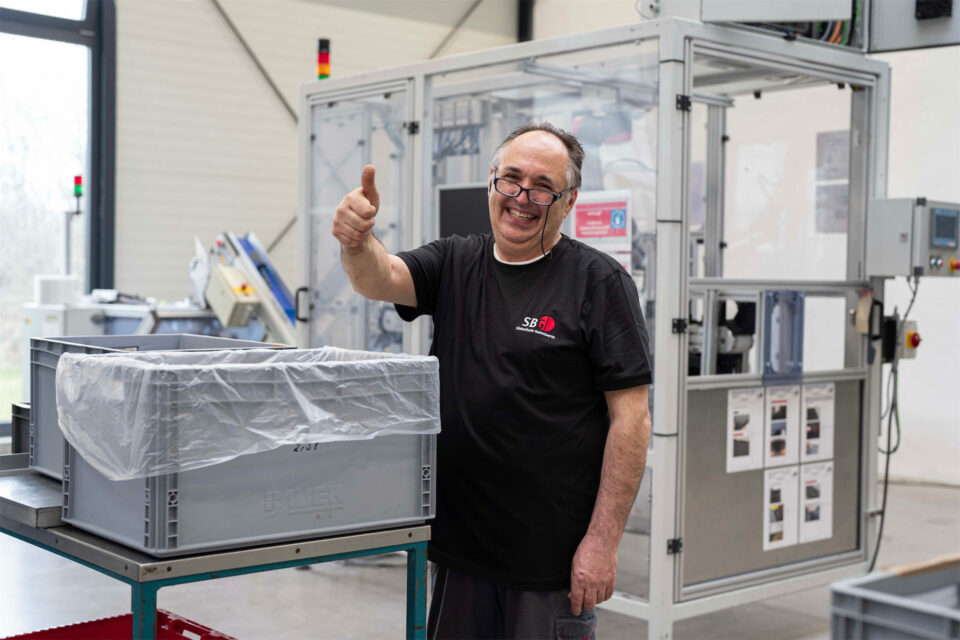 Ein fröhlicher Mitarbeiter in der Fertigung.